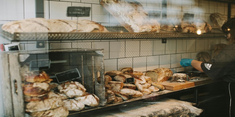 Variety of whole grain and white bread loaves showing nutritional comparison