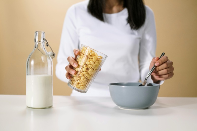 Healthy breakfast cereals with milk being poured into a bowl