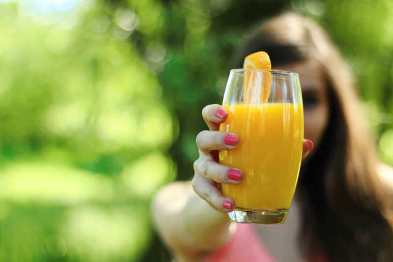 Fresh orange juice in a glass with orange slice garnish