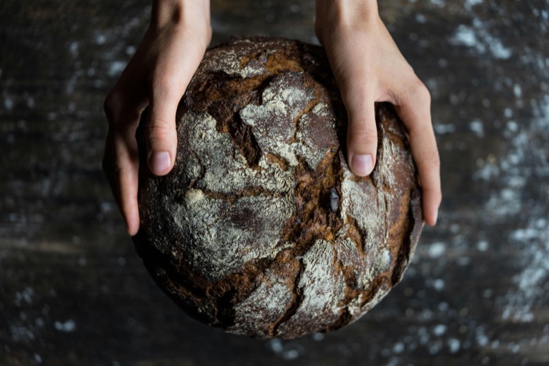 Artisanal sourdough bread with grains and seeds showing whole grain benefits and problems