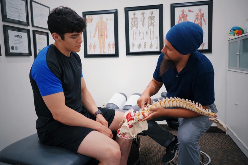 Professional chiropractor performing spinal manipulation therapy on a patient